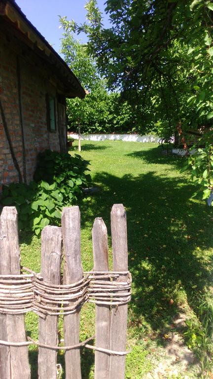 a wooden fence in front of a yard at Lodge Morava in Vrnjačka Banja