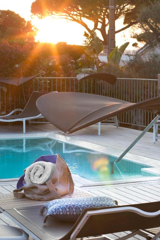 a towel is laying next to a swimming pool at Boutique Hôtel Villa Fabulite in Antibes