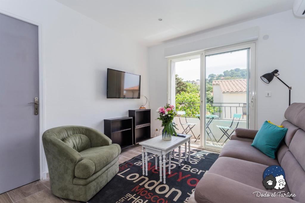 a living room with a couch and a chair at Cosy flat just by the sea - Dodo et Tartine in Le Pradet