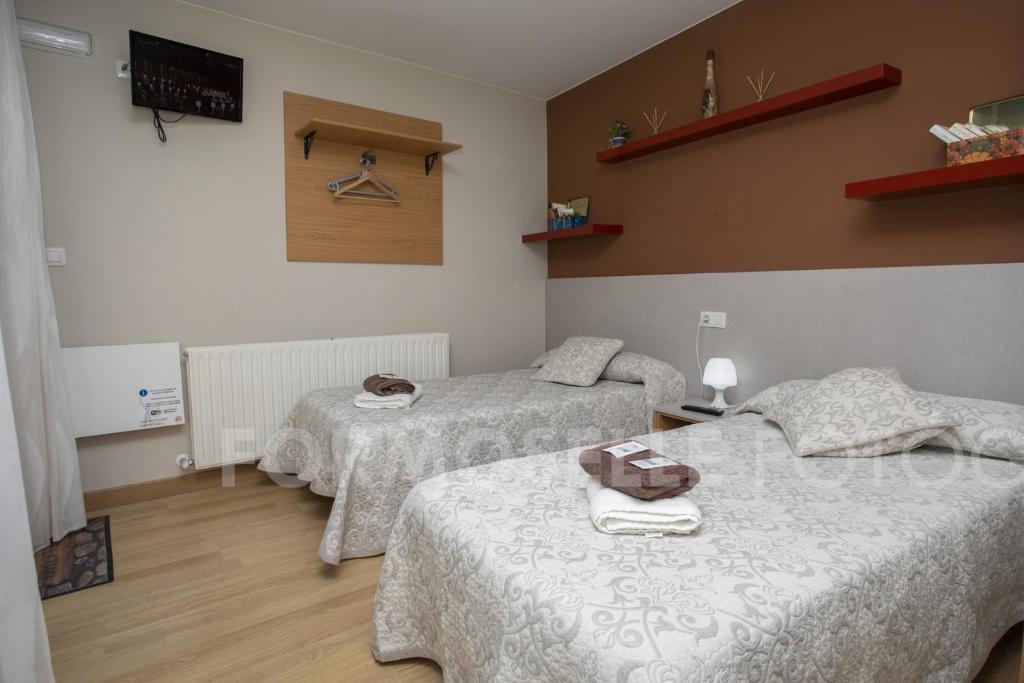 Łóżko lub łóżka w pokoju w obiekcie Pension Siete en el Camino