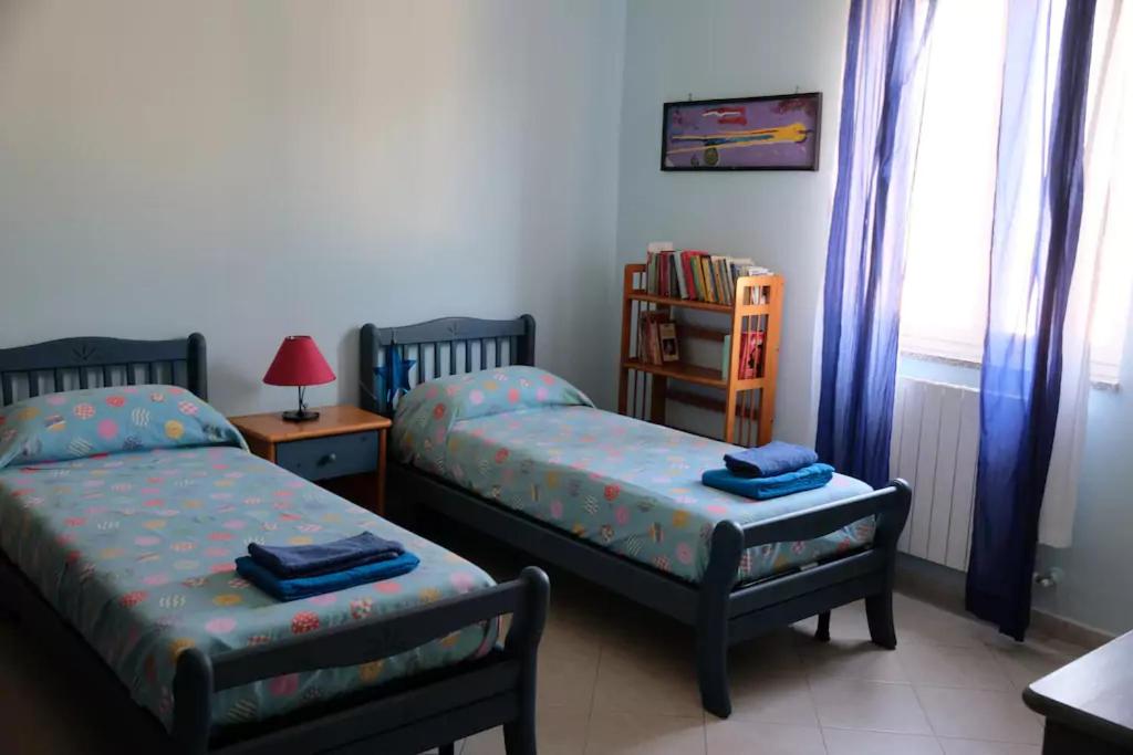 Postel nebo postele na pokoji v ubytování Lemontree House Bacoli