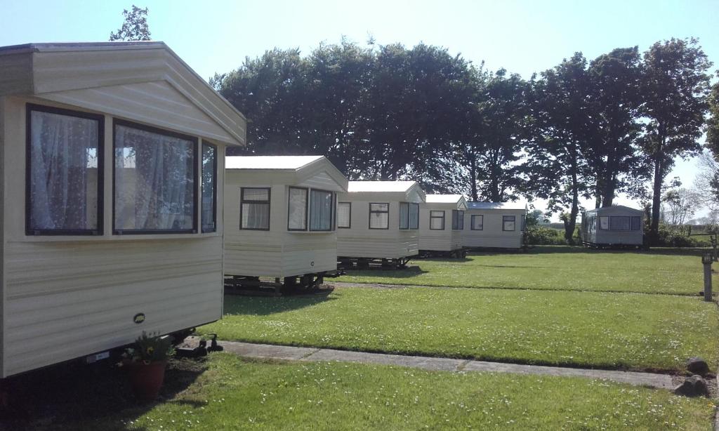 a row of mobile homes parked in a yard at Blackmoor Farm in Narberth