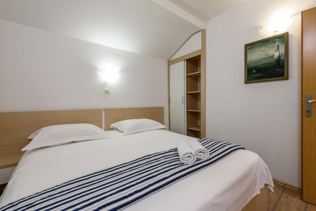 Posteľ alebo postele v izbe v ubytovaní Apartments Kudelik