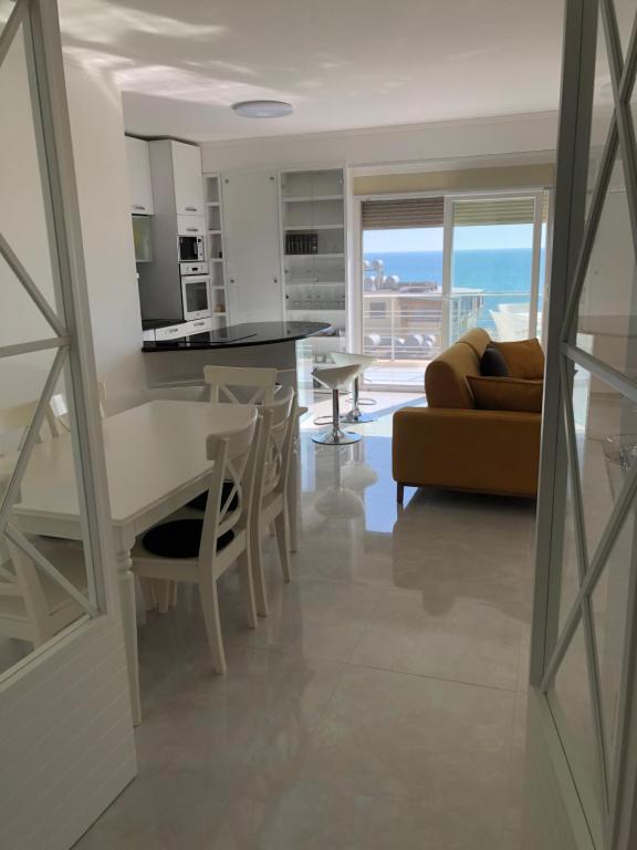 a kitchen and living room with a table and a couch at Alba Luxury Apartment in Durrës