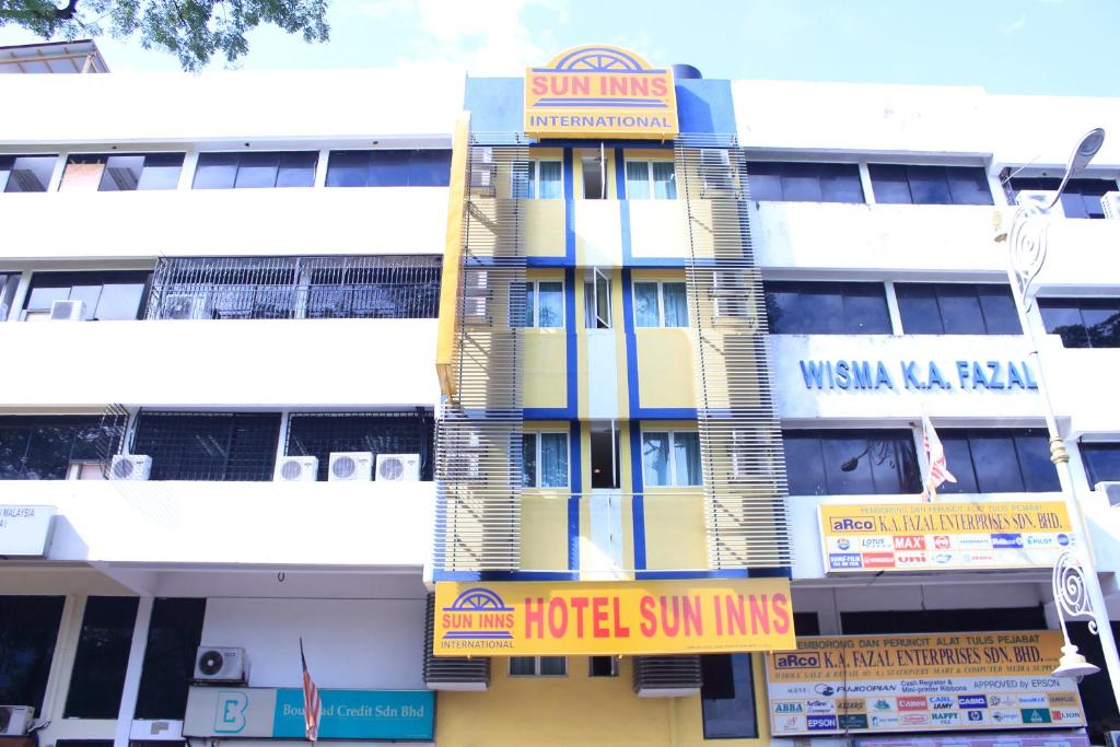 a building with yellow and blue signs on it at Sun Inns Hotel Sentral, Brickfields in Kuala Lumpur