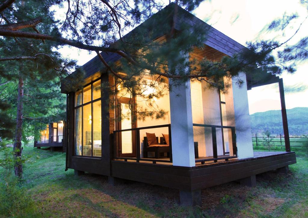 a tiny house in the woods with windows at Aytau Sporting-Hotel in Chemal