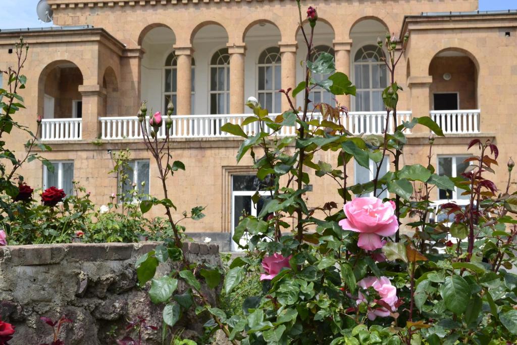 a building with a bunch of flowers in front of it at Health Resort Arzni 1 in Arzni