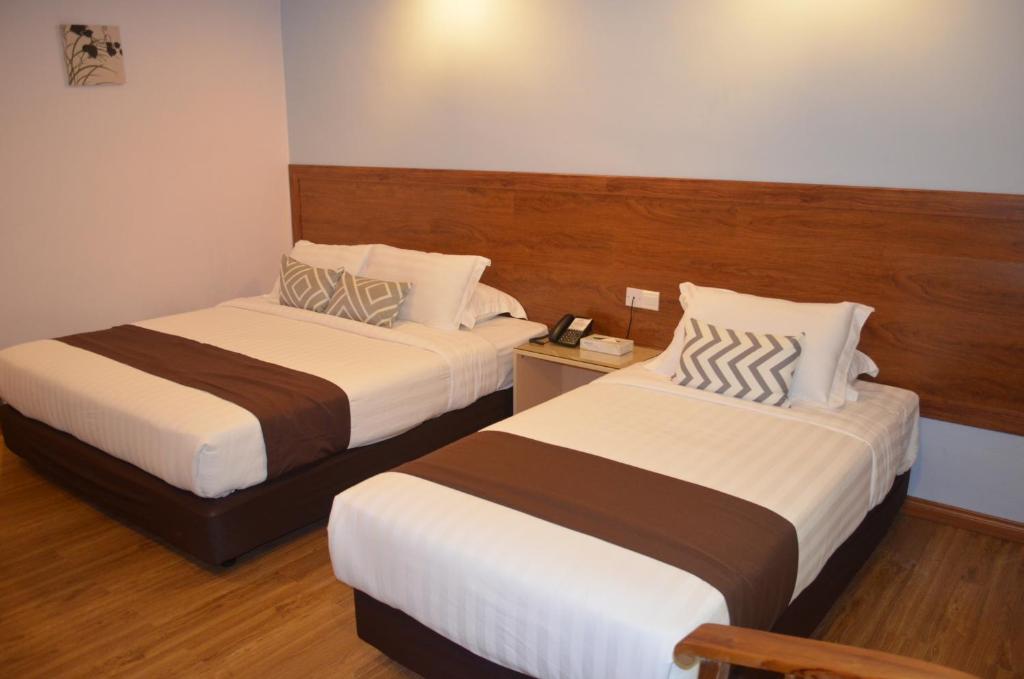Postel nebo postele na pokoji v ubytování TD Mutiara Hotel Semporna