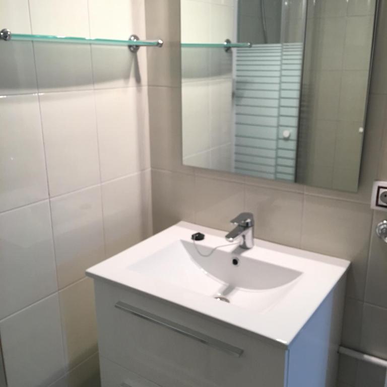 a bathroom with a white sink and a mirror at Aiguaneu Sa Carbonera in Blanes