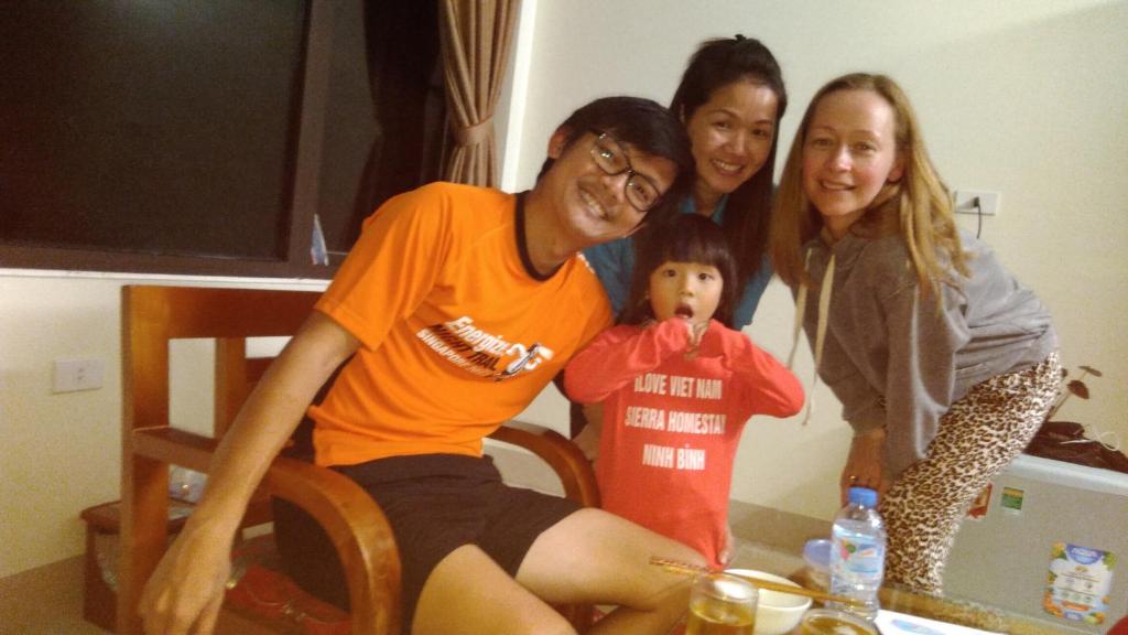 a group of three women posing for a picture with a child at Sierra Homestay in Ninh Binh