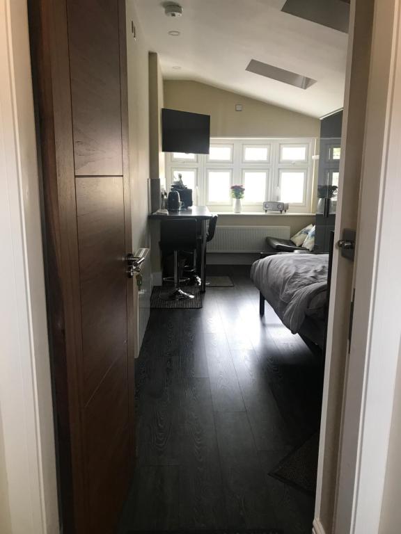 a bedroom with a bed and a desk and a window at Cauldwell Villas in South Shields