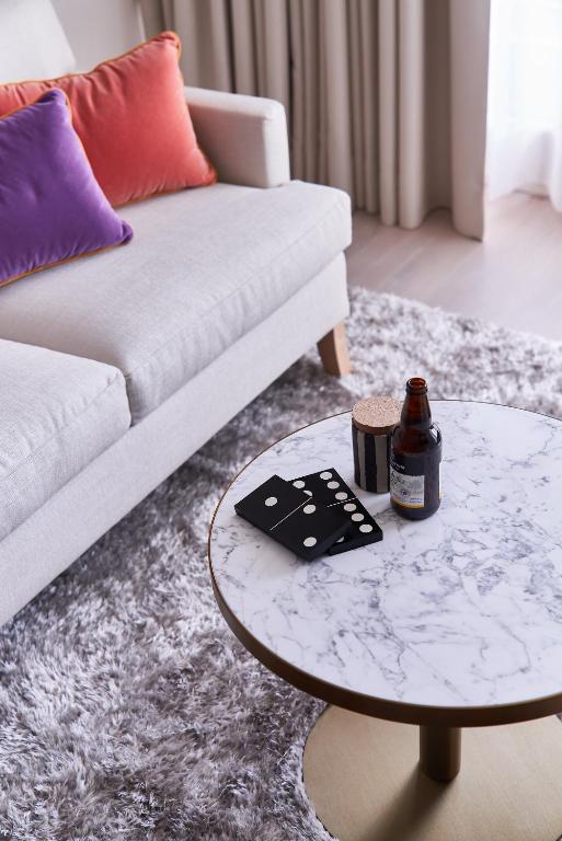 a living room with a couch and a table at SIDE, Hamburg, a Member of Design Hotels in Hamburg