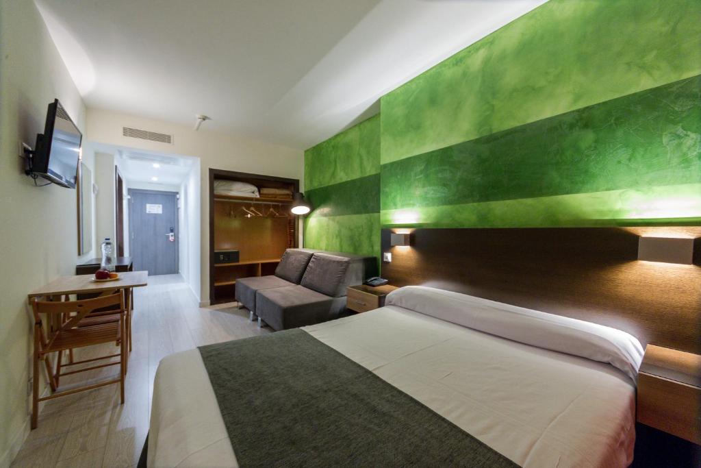Postel nebo postele na pokoji v ubytování Apartamentos Recoletos