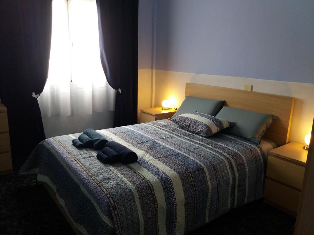 a bedroom with a bed with a striped blanket at el Bounty de Playa Chica in Puerto del Rosario