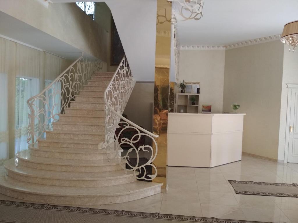 a staircase in a living room with a stair case at Hotel Elita in Odesa