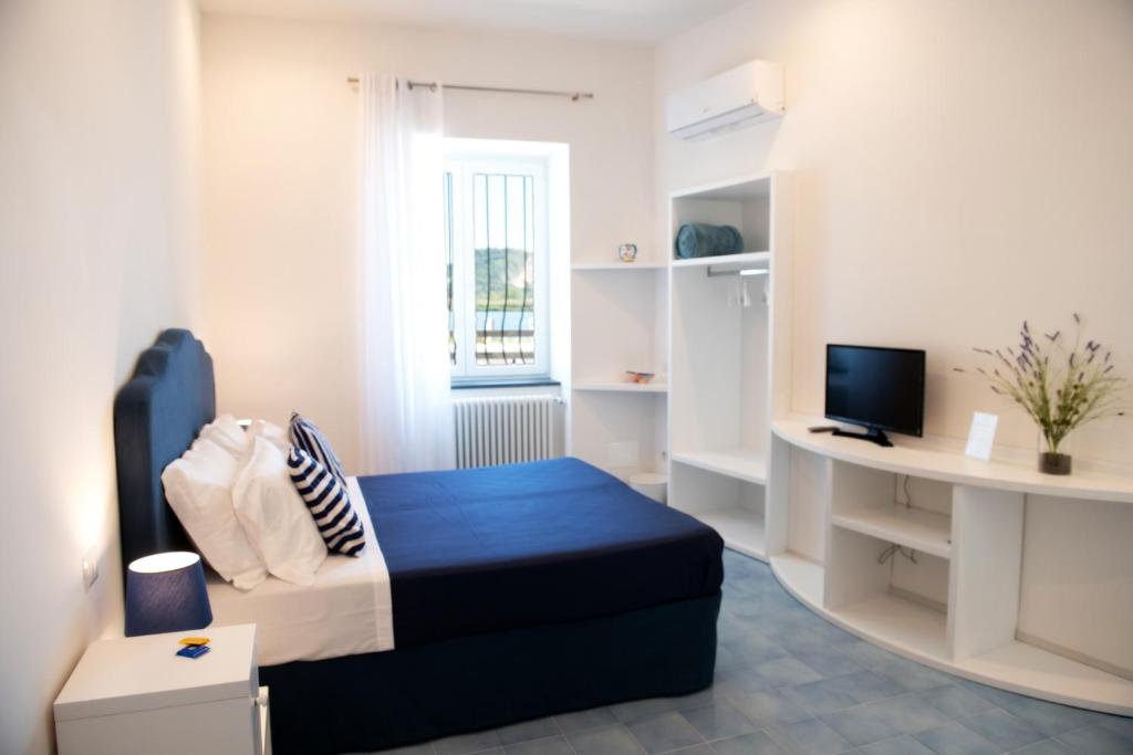 Postel nebo postele na pokoji v ubytování Domus Fortunae B&B