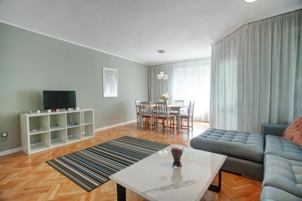 a living room with a couch and a table at Spacious flat close to the American Embassy in Sofia