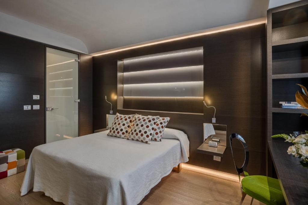 Postel nebo postele na pokoji v ubytování Hotel Mastino