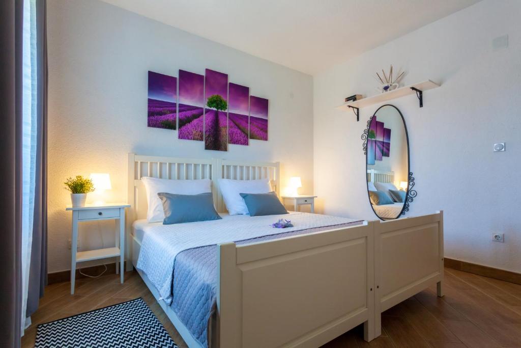 a bedroom with a bed and a large mirror at Apartment Placido Krk in Krk