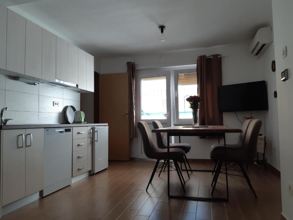 a kitchen with a table and chairs in a room at Apartment Nada in Opatija