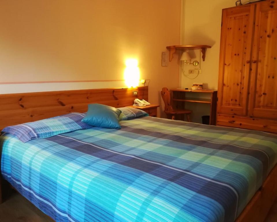 Postel nebo postele na pokoji v ubytování Albergo Krissin