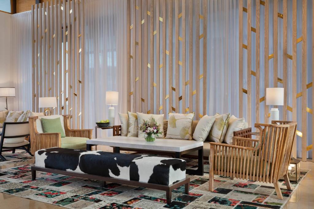 a living room with a couch and chairs at The Setai Sea Of Galilee in Ein Gev