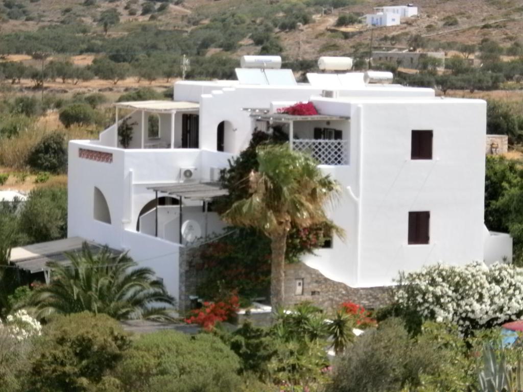 a white house with a hill in the background at amorgaia3 in Katapola