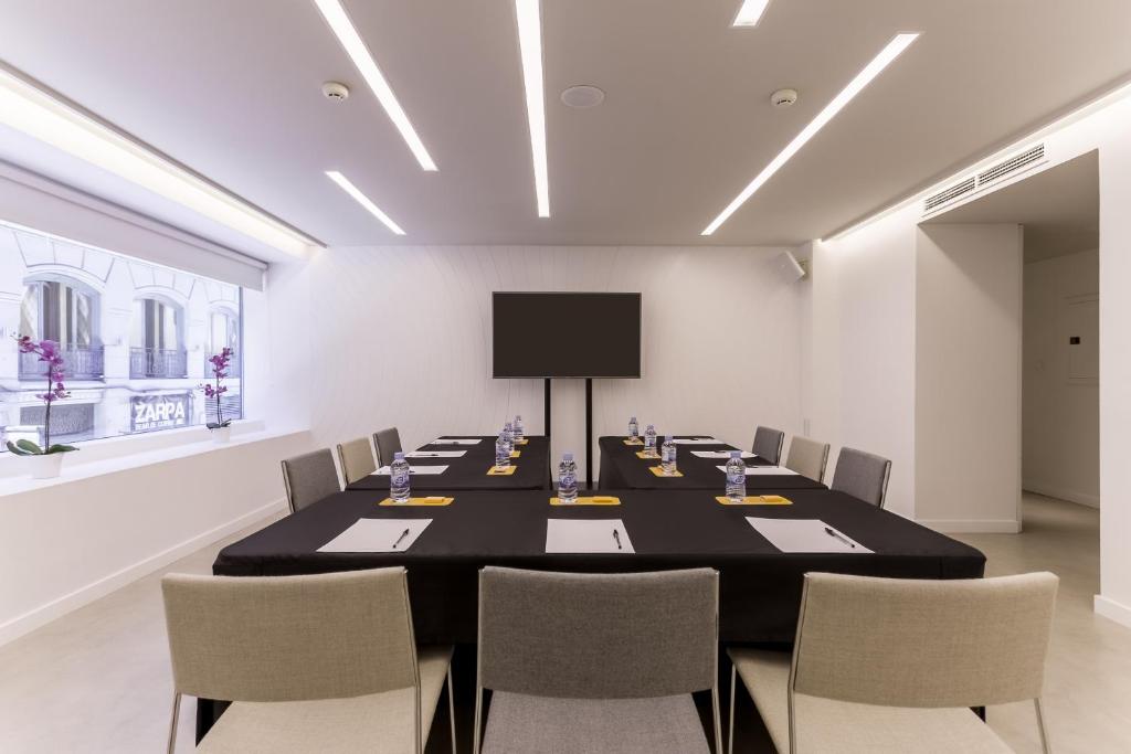 a conference room with a long table and chairs at Room Mate Oscar, Madrid in Madrid