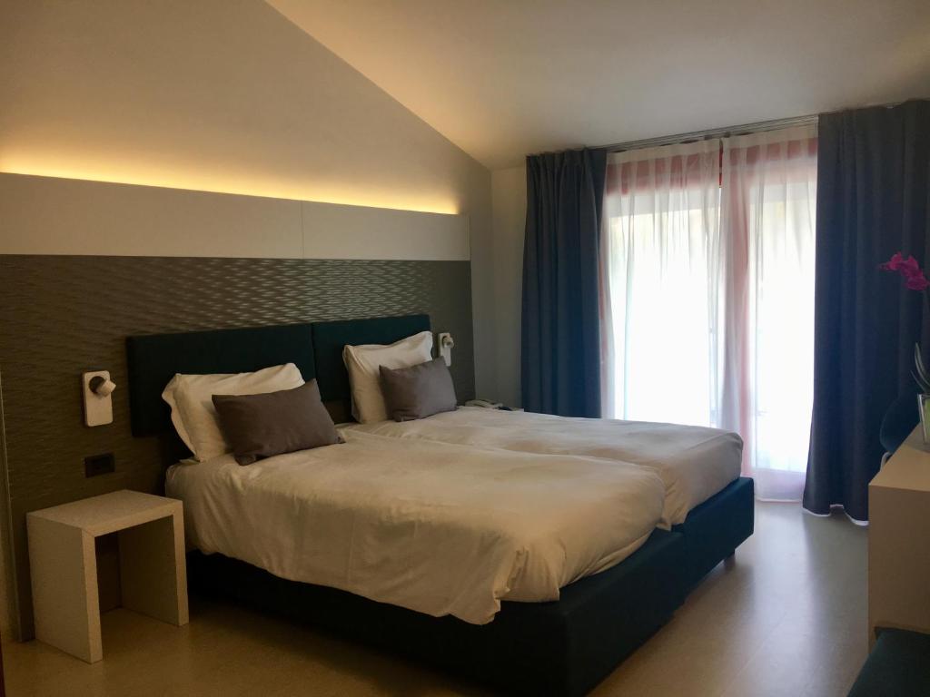 Postel nebo postele na pokoji v ubytování Hotel L'Approdo