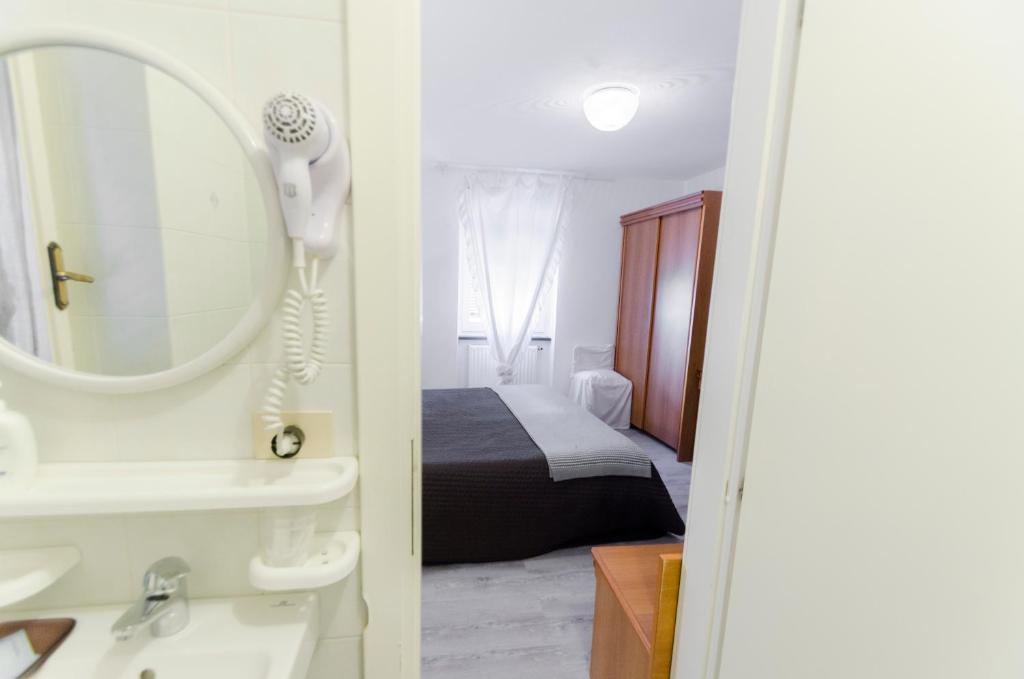 Postel nebo postele na pokoji v ubytování Albergo La Veranda