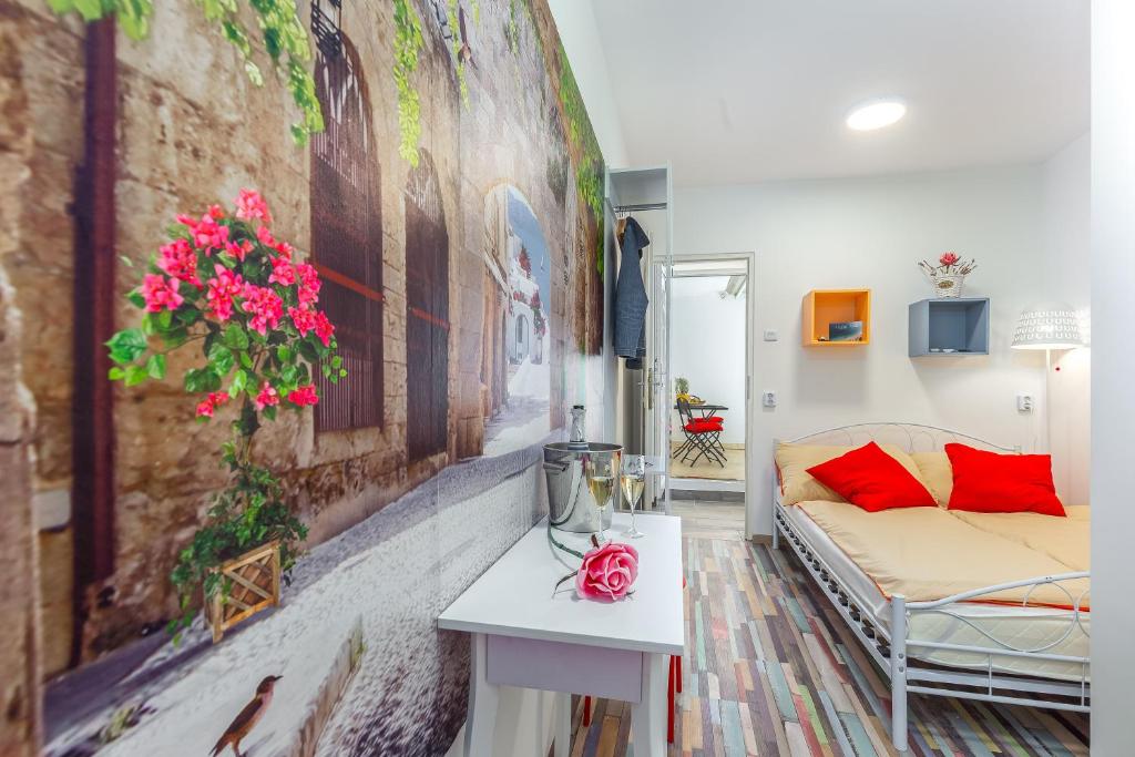 a living room with a couch and a painting on the wall at Center Rooms with terrace in Rijeka