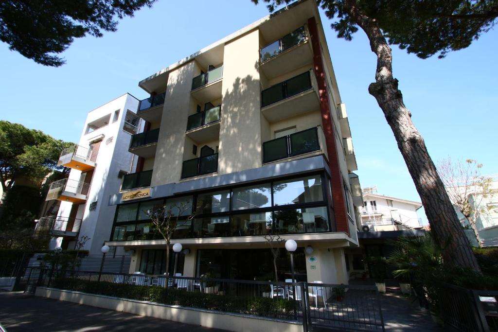 a building with a tree in front of it at Hotel Monica in Riccione