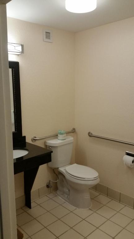 a bathroom with a toilet and a sink at Days Inn by Wyndham Chattanooga/Hamilton Place in Chattanooga