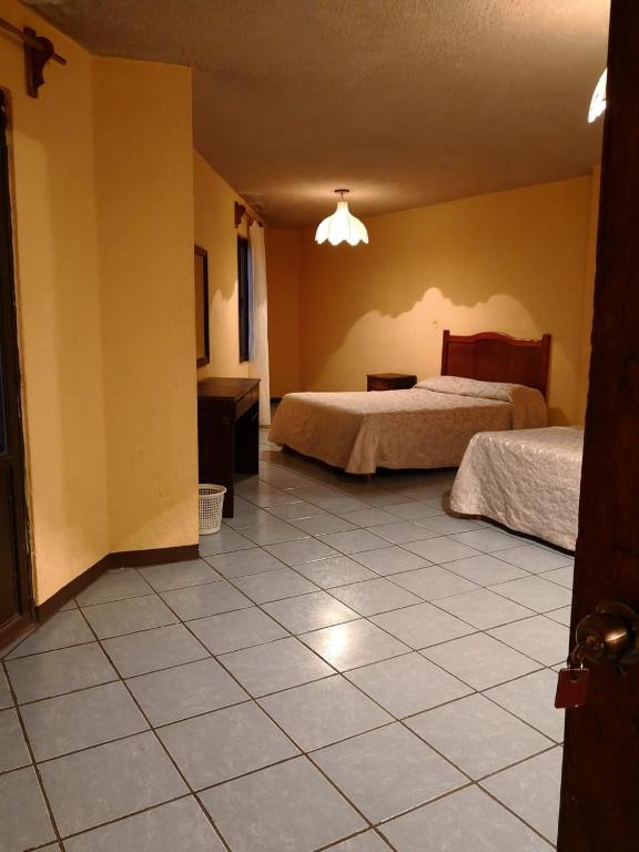 Postel nebo postele na pokoji v ubytování Hotel del Conde