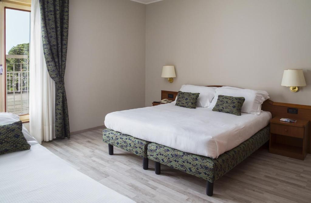 Postel nebo postele na pokoji v ubytování Hotel Beatrice