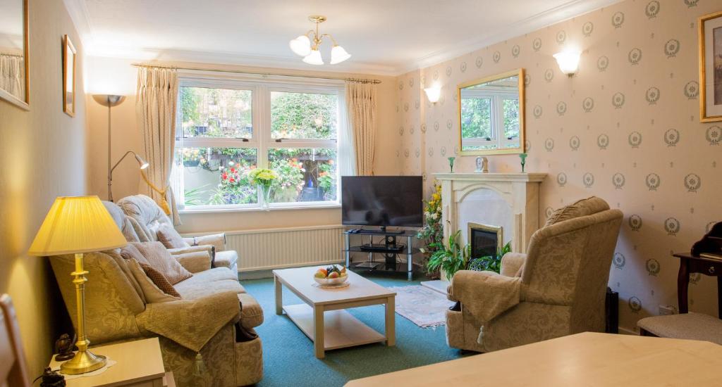 a living room with two couches and a fireplace at Oil Mill Lane Holiday Cottage in Berwick-Upon-Tweed