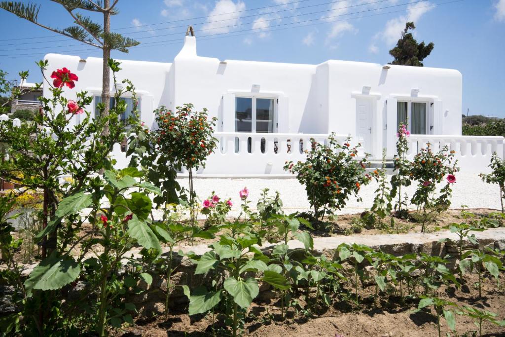 a white house with flowers in front of it at Anais in Mikonos