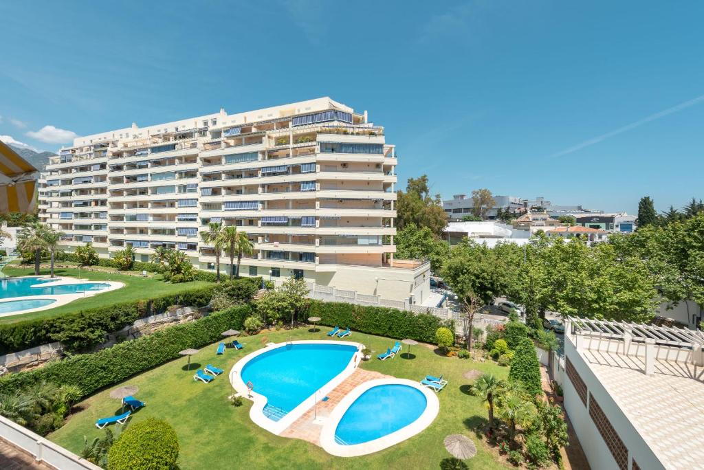 un apartamento con piscina y un gran edificio en Apartamento Vista Azul, en Marbella