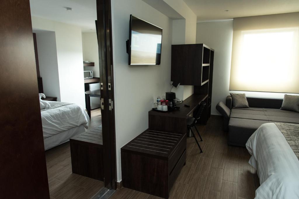 Postel nebo postele na pokoji v ubytování Lithio Hotel