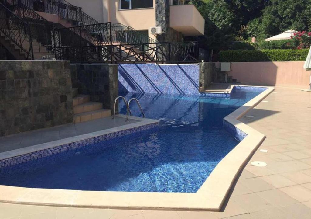 a swimming pool with blue water in a building at 62A Doctor Luben Lazarov Street in Varna City