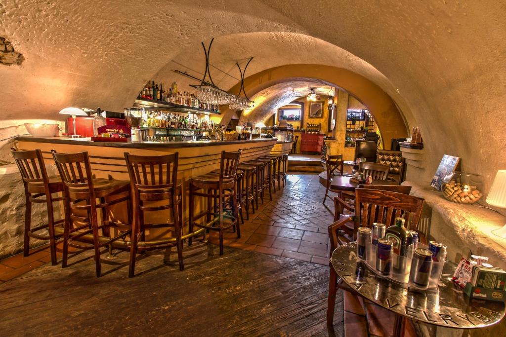 a restaurant with a bar with chairs and a counter at Studio Nicolas Prague in Prague