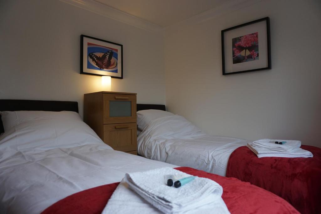 a hotel room with two beds and a dresser at Holt Apartment in Bristol
