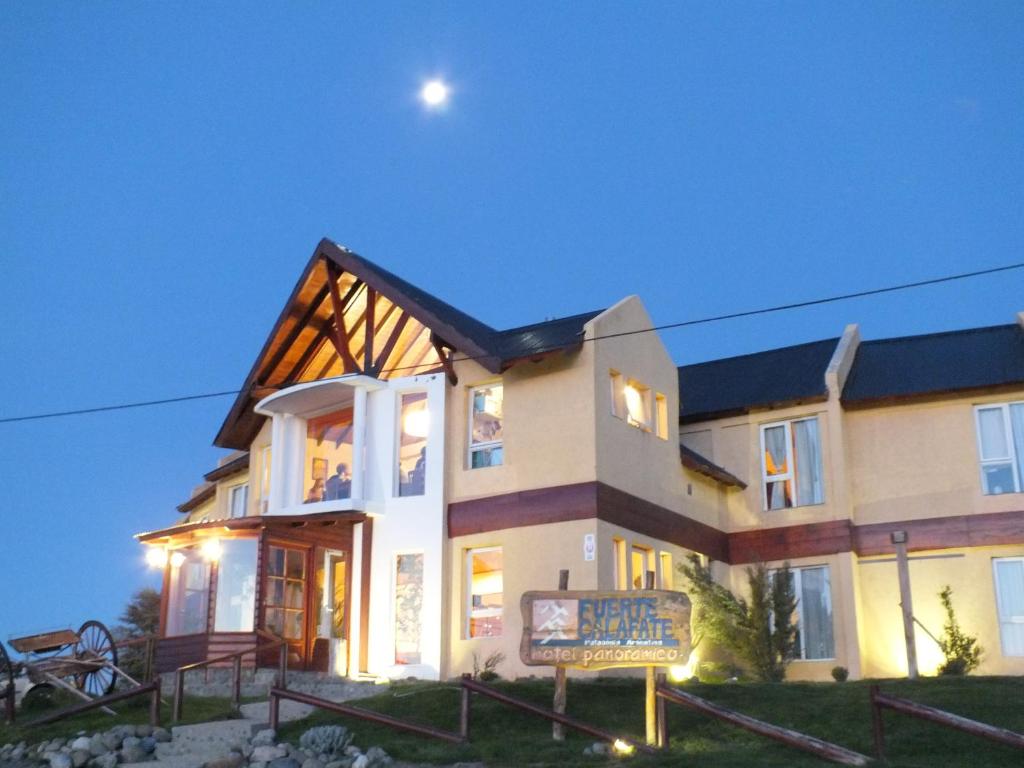 a large house with a sign in front of it at Fuerte Calafate Hotel Panorámico in El Calafate