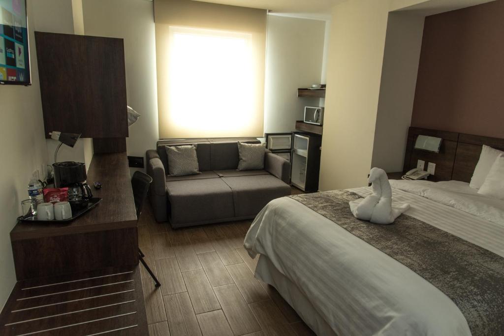 Postel nebo postele na pokoji v ubytování Lithio Hotel