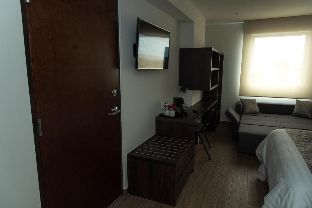 Postel nebo postele na pokoji v ubytování Lithio Hotel