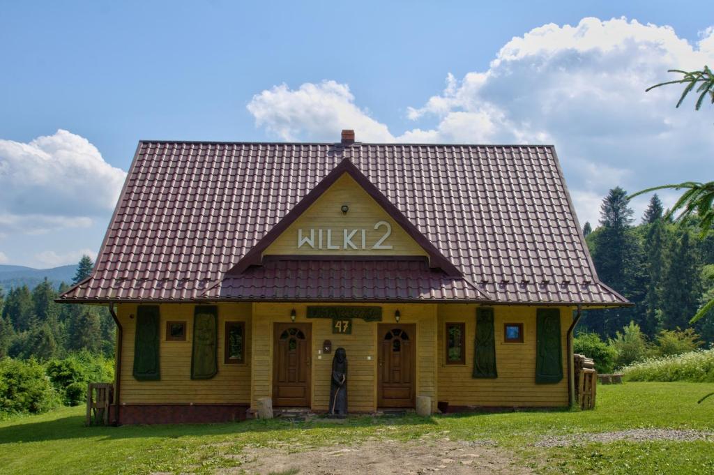 a small house with a sign that reads at Wilki2 in Wetlina