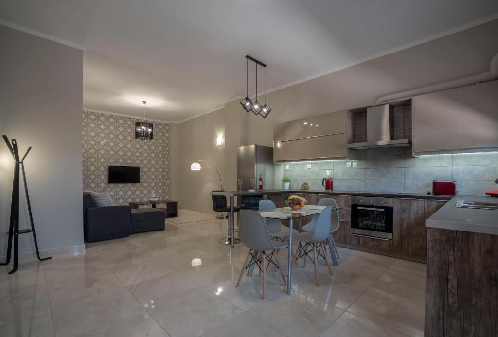 a kitchen and living room with a table and chairs at BO Home in Souda