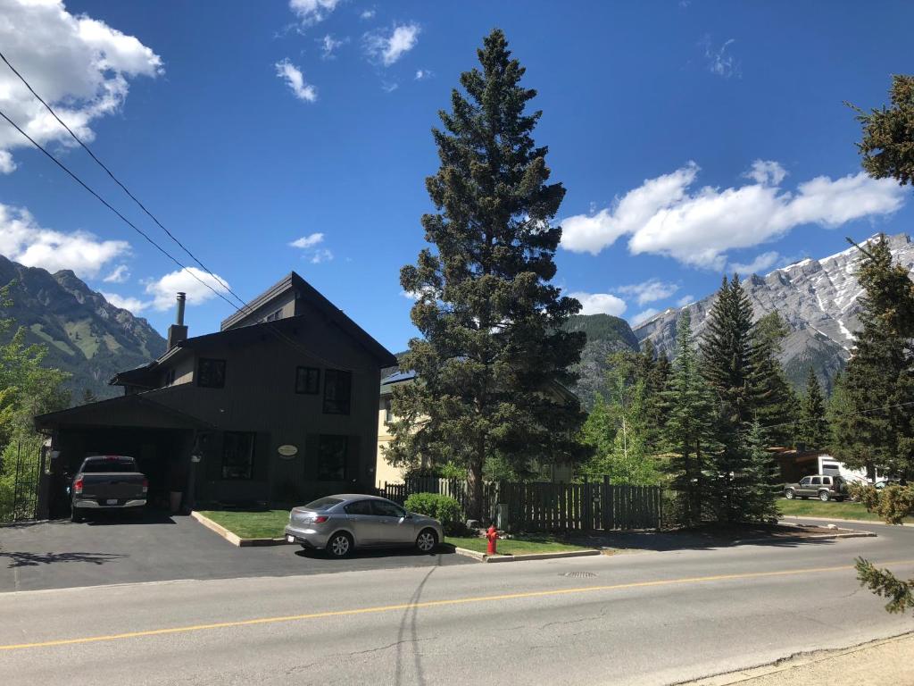 a car parked in front of a house with a tree at Mountain View Bed & Breakfast in Banff
