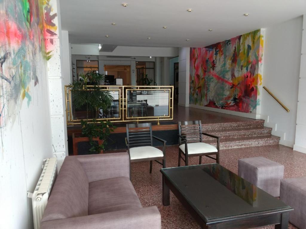 a lobby with a couch and chairs and a table at Hotel Milton in La Paz