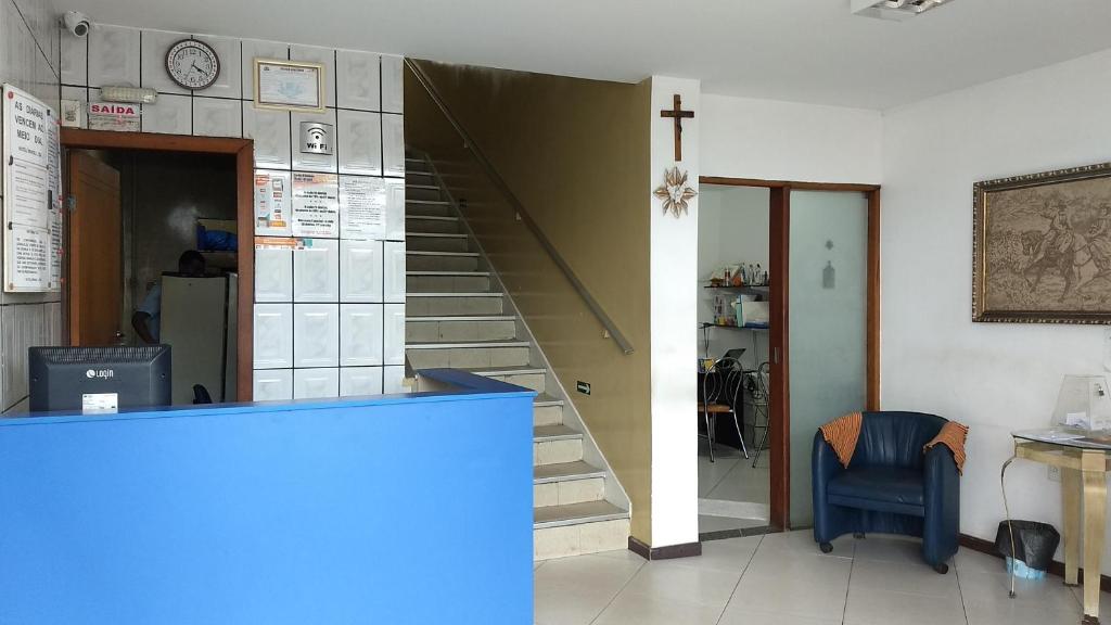 a room with a staircase and a cross on the wall at Hotel Brasil in Feira de Santana